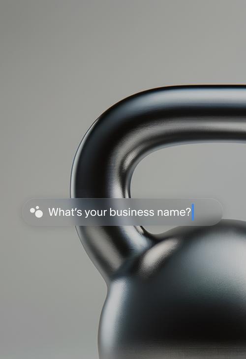 A close-up photo of a black kettlebell against a grey background, with a search bar overlay asking ’What’s your business name?’ The search bar includes a small three-dotted AI icon and a blinking cursor, suggesting an interactive business name input field.